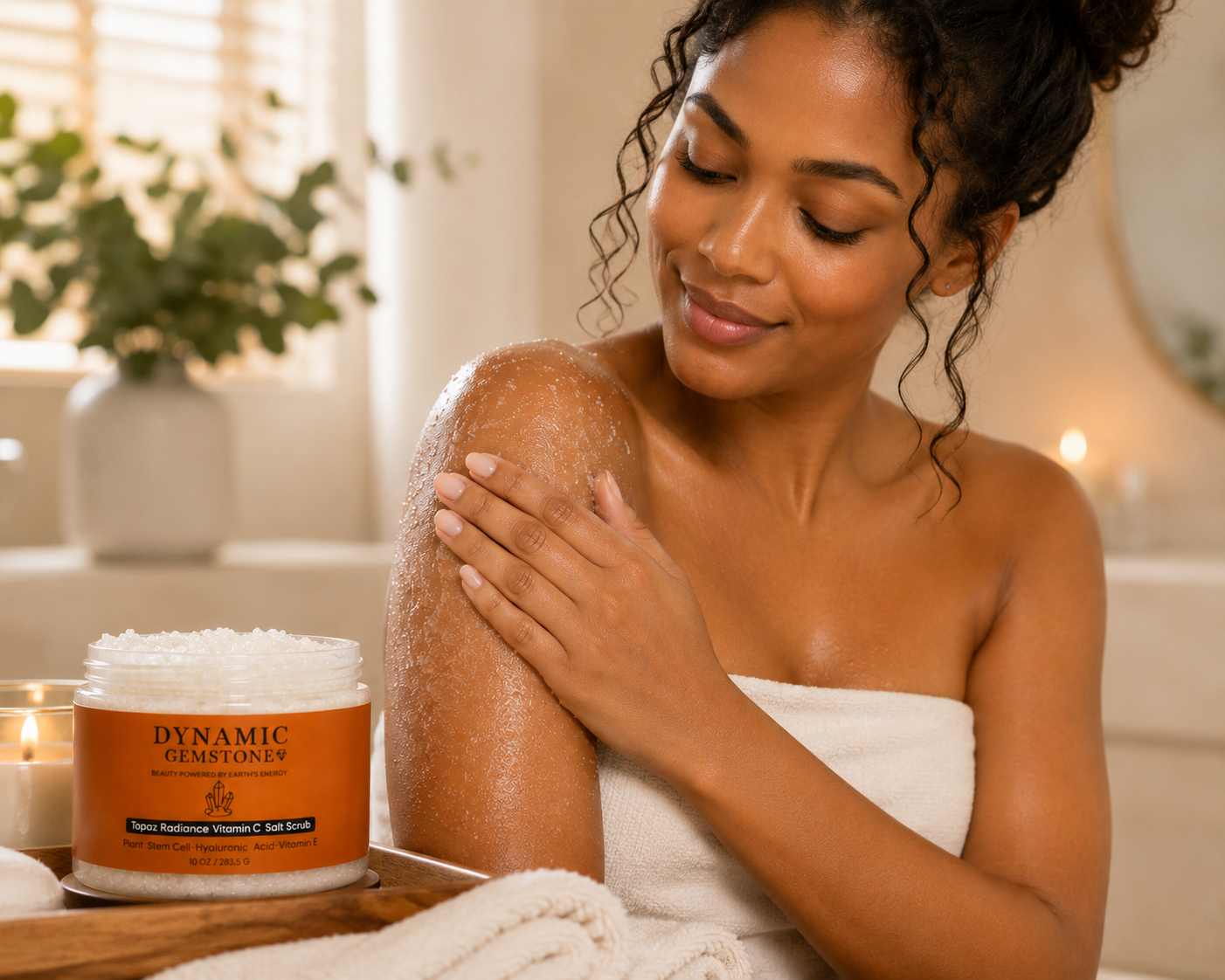 Model applying Dynamic Gemstone Topaz Radiance Vitamin C Salt Scrub in bathroom setting