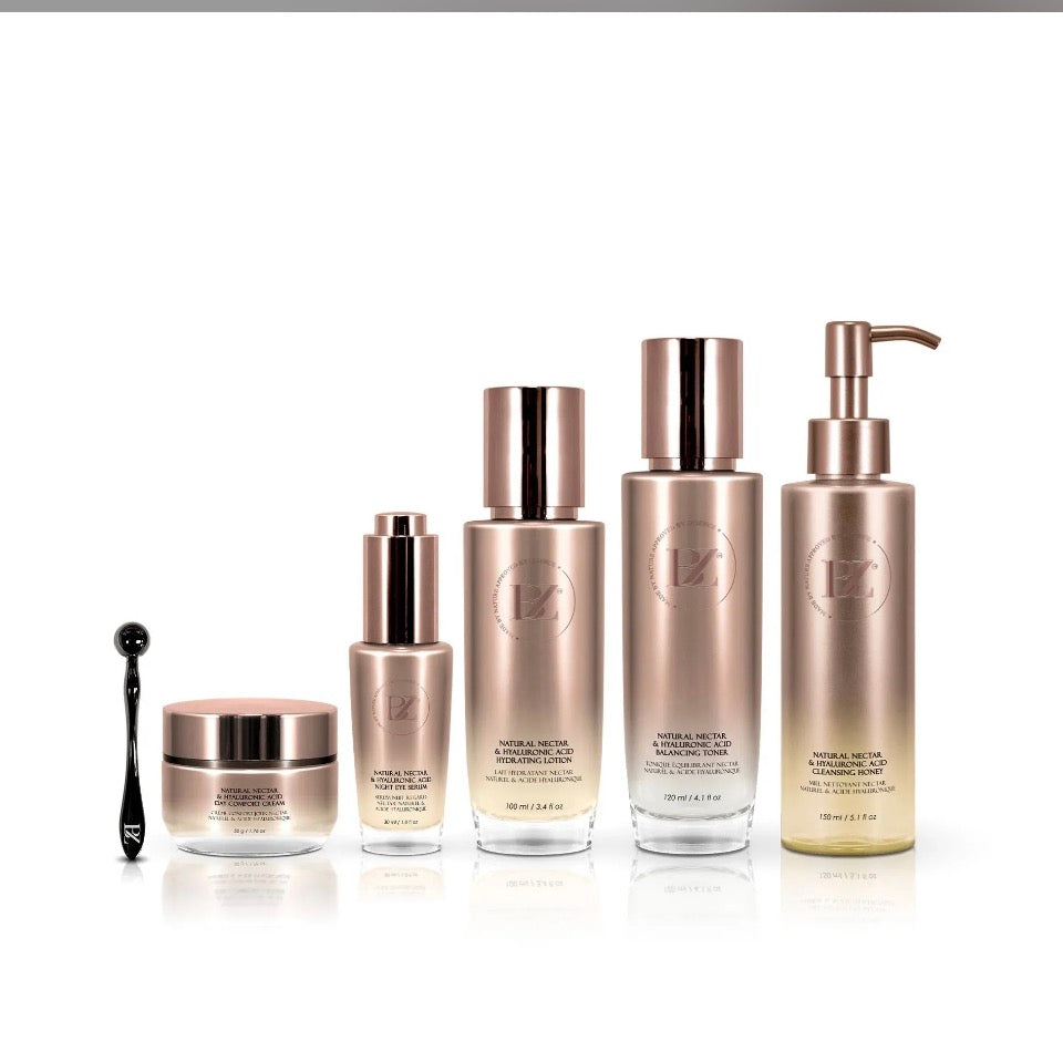 BZ Natural Nectar & Hyaluronic Acid 6-piece set - all rose-gold bottles and facial roller on white background