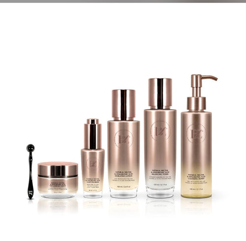 BZ Natural Nectar & Hyaluronic Acid 6-piece set - all rose-gold bottles and facial roller on white background