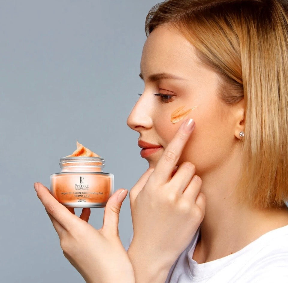 Model applying Prédiré Paris Argan Oil Cooling Facial Peeling Gel to cheek - lifestyle application shot