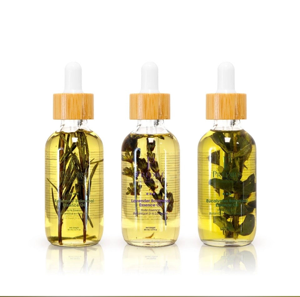 Prédiré Paris Botanical Essential Oil Trio - three clear glass dropper bottles with bamboo caps and real botanical sprigs in oil on white background