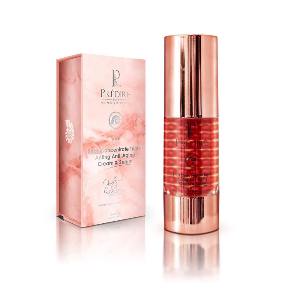 Prédiré Paris Snail Concentrate Triple Acting Anti-Aging Cream & Serum - rose-gold ribbed pump bottle next to blush-pink marble gift box with nautilus shell emblem on white background