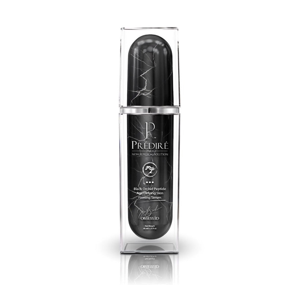 Prédiré Paris Black Orchid Peptide Age-Defying Skin Firming Serum - black marble-veined airless pump bottle in clear acrylic display case on white background