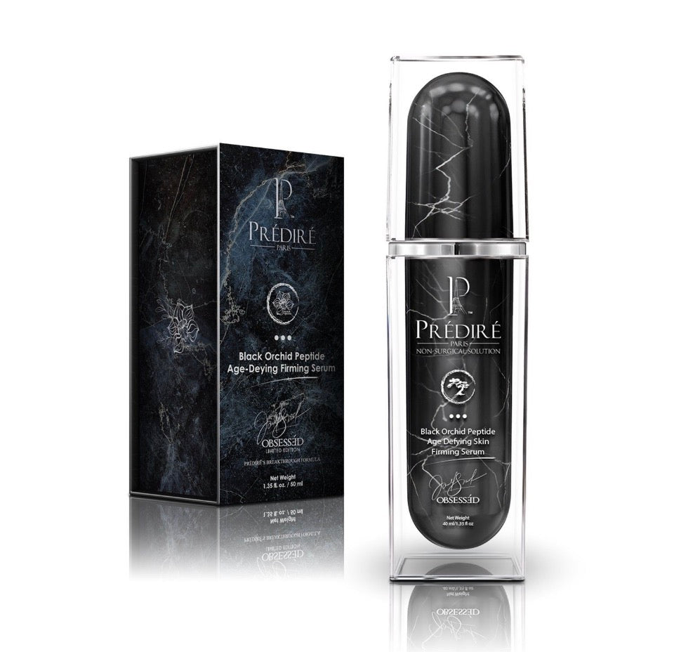 Prédiré Paris Black Orchid Peptide Age-Defying Skin Firming Serum - bottle in acrylic case next to black marble gift box with silver orchid illustration on white background