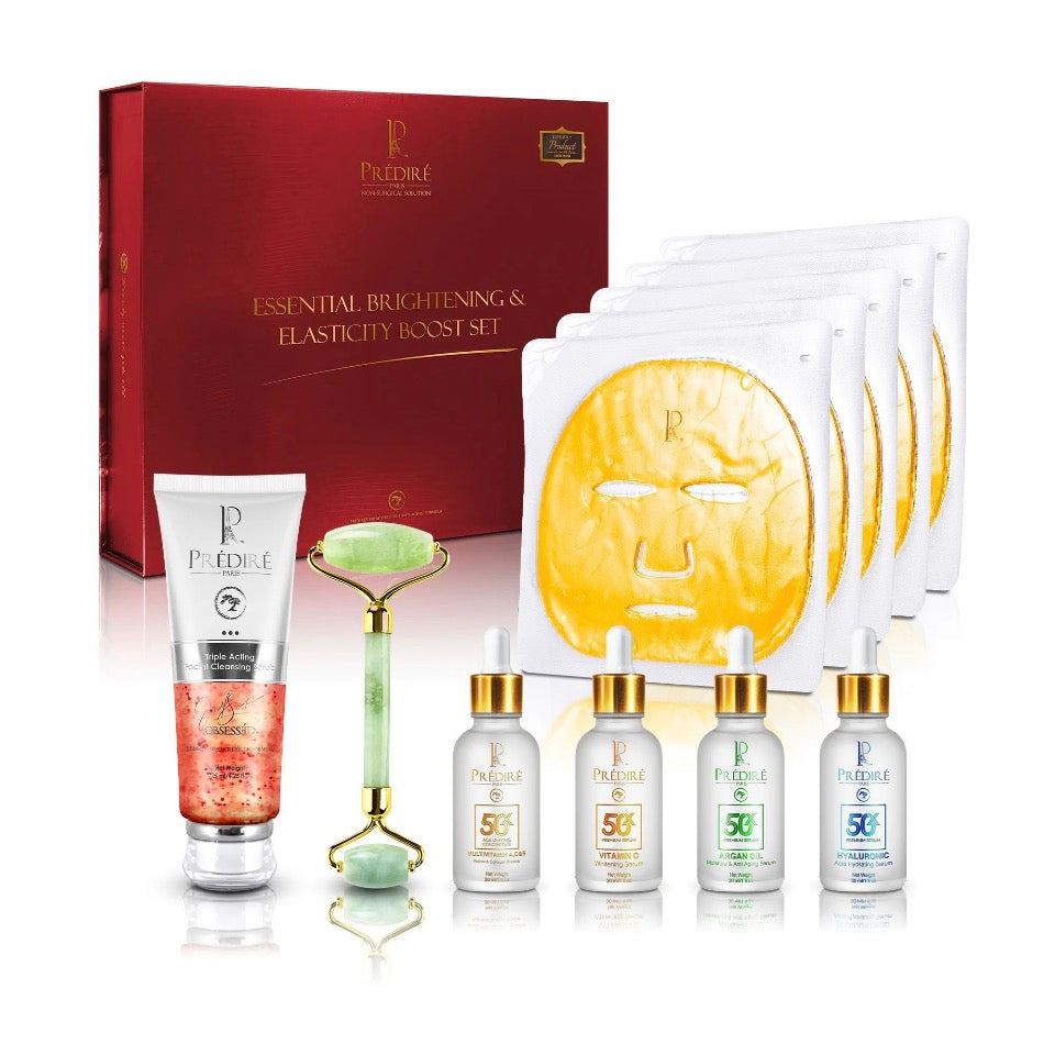 Prédiré Paris Essential Brightening & Elasticity Boost Set - all 10 pieces displayed in front of deep crimson gift box including 4 gold masks, 4 serums, jade roller and cleansing scrub