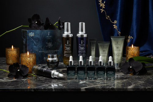 Prédiré Paris Black Orchid Collection luxury editorial lifestyle shot on dark marble with orchid flowers